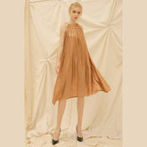 Sleeveless gathered organza dress with relaxed A-line silhouette and tie shoulder detailing